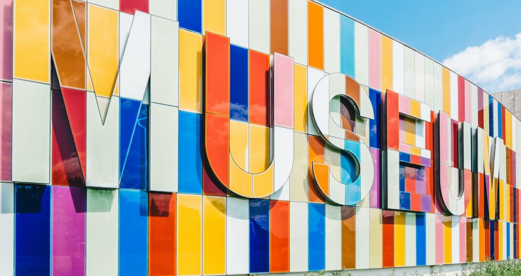 Colorful outside front of a building with MUSEUM written on it.