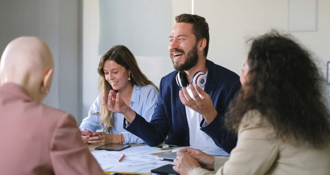 People sitting around a table discussing a problem of mutual interest.
