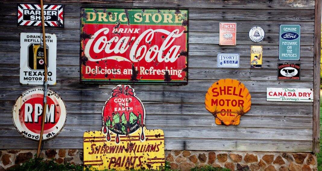 A gray wood plank wall full of metal signs illustrated how we can market our research